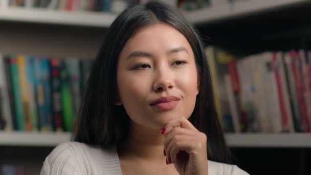 Portrait Pensive Korean Woman Standing Library Bookshelf Think Ponder Deep — Stok video