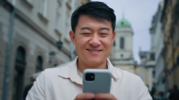 Close Smiling Asian Man Tourist Standing City Outdoors Mobile Phone — Stock Video