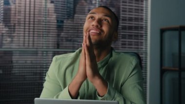 African american man businessman sits in office folded palms pray to god ask for good luck in new project ethnic entrepreneur making request gesture make wish at workplace hope for successful result