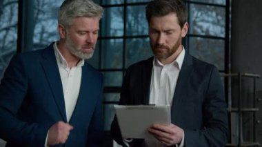 Caucasian men businessmen walk in office discuss project business partners conclude agreement mature manager explain startup details young entrepreneur sign contract handshake partnership cooperation