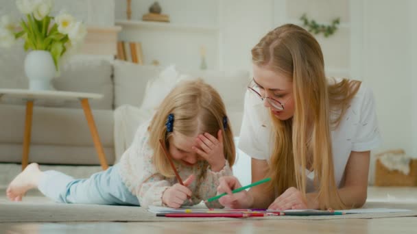 Caring Caucasian Mum Nanny Babysitter Helping Cute Kid Daughter Teaching — Stockvideo