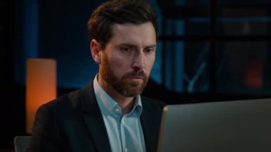 Adult businessman sad 40s caucasian man entrepreneur work with computer in evening office tired exhausted male worker fail online job read bad news receive rejected email financial loss difficulties