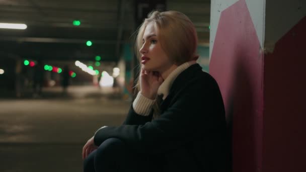 Scared Stressed Blonde Woman Sitting Car Parking Dark Hall Indoor — стоковое видео