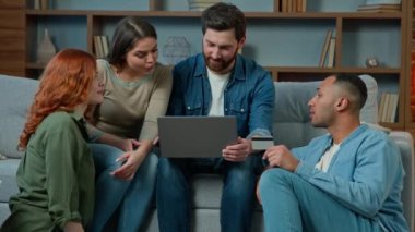 Excited team diverse men women use credit card for online payment on laptop multiethnic group of business people friends colleagues winners celebrate success earn money win victory discounts cashback