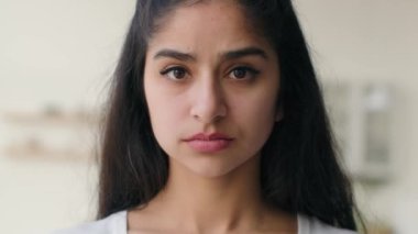 Close up head shot frustrated sad lonely Indian ethnic woman businesswoman looking at camera pensive anxious sight depressed thoughts portrait girl worried with health problem guilt loneliness despair