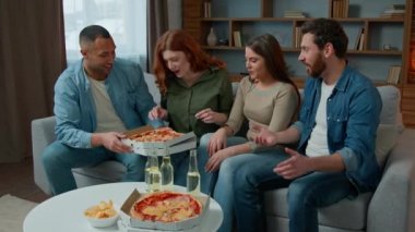 Multi ethnic group team people sit at festive table share italian pizza with men women diverse multiracial friends talking laughing eat meal slices tasty lunch eating dinner celebrating party at home