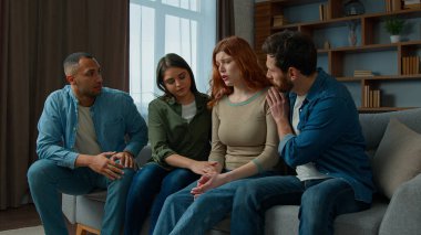 Sad desperate girl talk share problem with friends in group psychological therapy at home diverse ethnic women men help upset girl. Caring multiracial teammates listen complaints support give advice