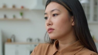 Close up view lonely Asian woman thoughtful pensive korean girl looking in distance deep thoughts worried sight sad alone japanese female businesswoman thinking over problems bad news loss depression