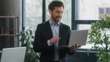 Happy excited businessman in office checking email on laptop read good news man winner successful entrepreneur receive reward bonus celebrating business success victory financial market growth concept