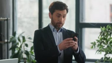 Angry furious businessman using phone in office loses online lottery losing bet on internet worried to bad result financial loss stressed upset man entrepreneur disappointed failure fails in business