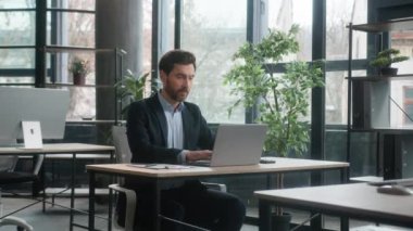 Caucasian businessman professional manager typing on laptop work in modern office write notes market research information man entrepreneur analyze data on internet develop business plan using computer