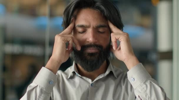 閉じた目で疲れ疲れインド人男性マッサージ寺院頭痛のパニックビジネスマンに苦しんで不健康な男慢性的な痛みを伴う片頭痛を感じて困難な意思決定を行う — ストック動画