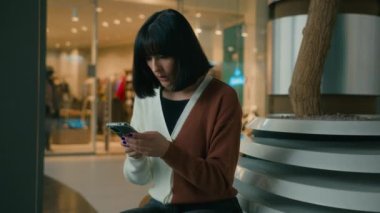 Indoors girl lady female with phone annoyed sad upset stressed woman shock bad news anxious with mobile app failure, application with smartphone crash banking mistake lost money boyfriend breakdown
