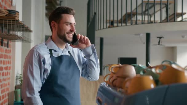 Blanke Man Coffeeshop Werknemer Schort Praten Mobiele Telefoon Achter Cafetaria — Stockvideo