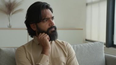 Düşünceli Arap Müslüman adam, Hintli erkek ev sahibinin derin düşüncelere daldığını düşünüyor. Düşünceli iş adamı çözümünde beyin fırtınası yapmayı düşün.