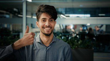 Portrait happy indian ethnic man professional businessman entrepreneur agent manager stand in office company smiling male looking at camera arabian adult 25s business owner millennial posing indoors