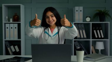 Happy doctor young practitioner nurse woman female pediatrician make thumb up hand gesture recommend health insurance good healthcare service promote immunization vaccination approved medicine quality