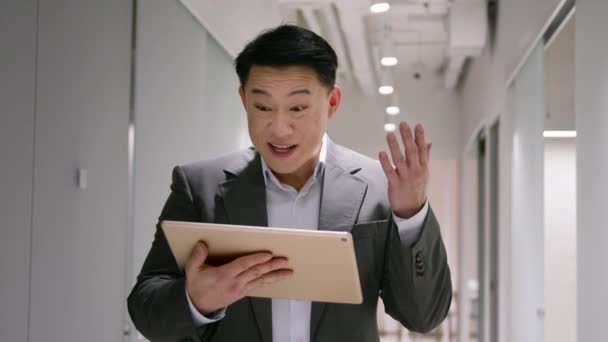 兴奋的成熟商人亚洲男人在办公室走廊与数码平板电脑赢得商业成功押注彩券男子40多岁的韩国人尖叫着接受大奖 — 图库视频影像