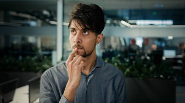 Thoughtful puzzled indian arabian man office manager smart creative concentrated worker businessman think plan ponder new idea brainstorming mind thoughts create project planning business development