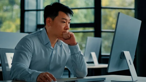 Asian businessman korean man work online at workplace difficult hard job get incorrect error in computer failure business problem. Upset anxious male disappointed about mistake bad internet in office