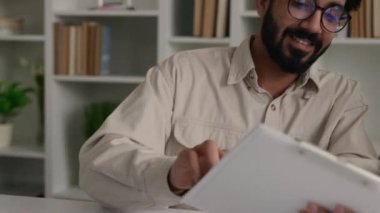 Çok ırklı ofis çalışanı müşteriyle konuşuyor. İki farklı iş adamı laptopun iş dünyası koçu, stajyer doktorlara sosyal medyayı öğretiyor. Verimsiz takım çalışmasını görmezden geliyorlar.