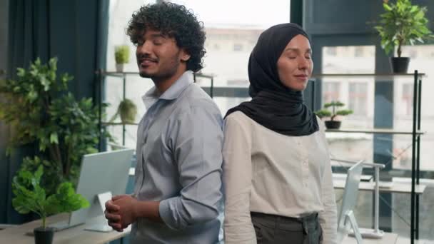 幸せな多様なスタッフ従業員アラビア語インド人男性ビジネスマンとイスラム教徒の女性ビジネスマンヒジャーブ州の喜びの共同労働者カメラの笑顔を見て親指を表示ビジネスオフィスで良いアイデアのようなジェスチャー — ストック動画