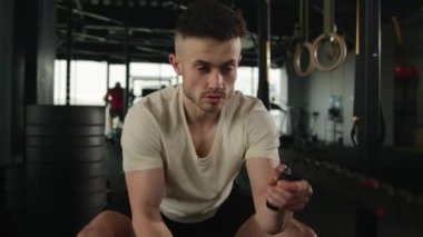 Kas gücü olan sporcu Kafkas sporcusu fitness spor salonunda yoğun egzersiz dalgaları savaş halatları spor ekipmanları fiziksel dayanıklılık egzersizi vücut geliştirme zorluğu.