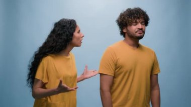 Çok ırklı çift çeşitli arkadaşları olan Hintli erkek İspanyol kadın kavga ediyor. Öfkeli anlaşmazlık, aile sorunu, kötü ilişki, kötü jest kızı, mavi stüdyo arka planında tartışıyor.