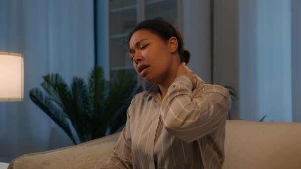 病気疲れアフリカ系アメリカ人のUnwell女性感じる痛みで首脊髄腰痛で夜家に病気女性の女の子マッサージ痛みを伴うバック軽減痛み健康問題傷害外傷不快感筋肉けいれん — ストック動画