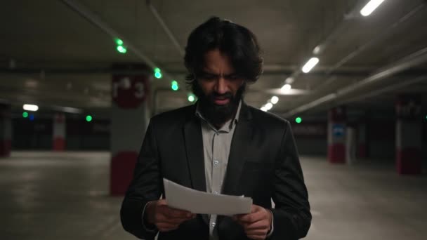 Angry Stressed Arabian Businessman Reading Paper Document Walking Underground Parking — Stock Video