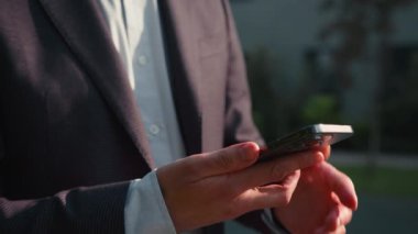 Hareketli erkek eli cep telefonu numarasını arıyor müşteriyle konuşuyor dışarıda cep telefonuyla konuşan beyaz iş adamı dışarıda neşeli bir adamla konuşuyor ve gülümsüyor.