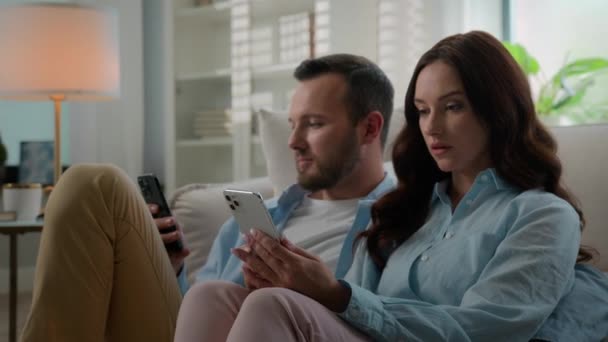 Involved Caucasian Couple Man Woman Home Using Phones Mobile App — Vídeo de Stock