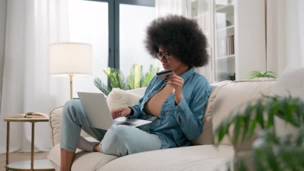 アフリカ系アメリカ人女性は ラップトップとクレジットカードの故障エラーミスでオンラインで支払おうとしています 安全な番号の少女は ショッピングの問題でイライラします 支払いを拒否 家庭での銀行のトラブルインターネット取引 — ストック動画