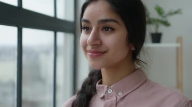 Düşünceli bir rüya Arap Hintli genç kız ofiste rüya gibi etnik kadın yalnız başına sabahleyin pencereden bak kadın iş kadını hareket ediyor uyum dengesini hisset
