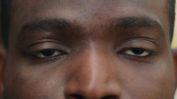 クローズアップビューの詳細 アフリカ系アメリカ人男性 ダークアイ クローズ オープンブリンク 眼科の視力 視力を見る 視力の問題 病気の顔の表情 レーザー手術を見る — ストック動画