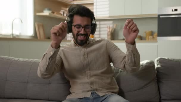 Happy Relaxed Arabian Man Homeowner Listen Music Headphones Enjoy Rhythm — Stock Video