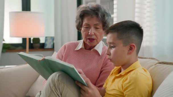 Loving Elderly Woman Retired Grandmother Reading Book Grandson Home Sofa — Stock Video