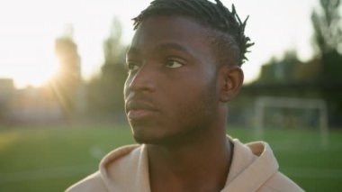 Kapalı portre Afro-Amerikan güçlü sporcu sabah güneş ışığını kaçırıyor erkek sporcu erkek sporcu koşucu şehrin dışında sağlıklı yaşam tarzı spor salonunda düşünceli bir vizyon.