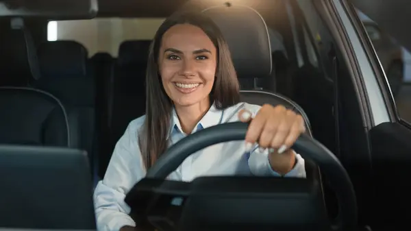 白种人女女司机坐在车内租车里笑着高兴地看着相机开车喜欢买新车笑着做生意的女服务员停车场 — 图库照片