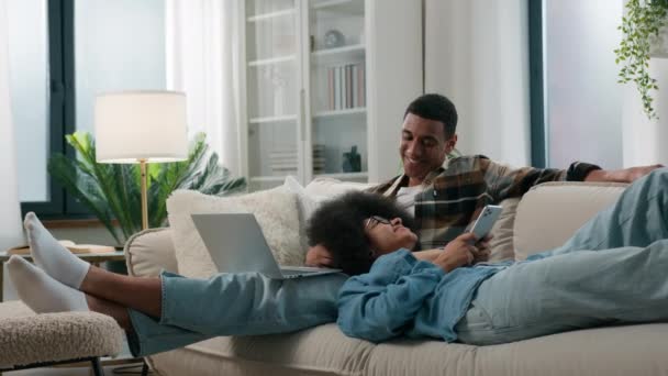 Chilling Afro Amerikaans Ontspannen Paar Bank Thuis Samen Gadget Internet — Stockvideo