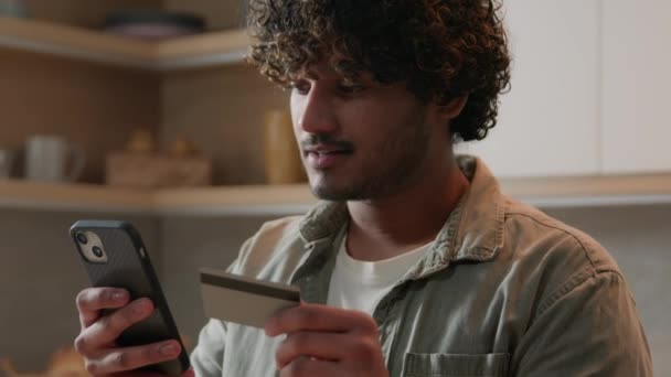 インドのアラビア人男性クレジットカードホルダー 携帯電話を使用してオンライン購入消費者商品を注文する キッチンからEコマースのウェブサイトで食品配達ショッピングサービス 男性のスマートフォン取引 — ストック動画