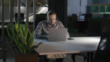 Hareket eden beyaz iş adamı dizüstü bilgisayara bakıp haykırıyor bilgisayar başarısı ile çığlık atıyor işveren işadamı ofis çalışanı geceleri el hareketi yapıp başarıya ulaşıyor.