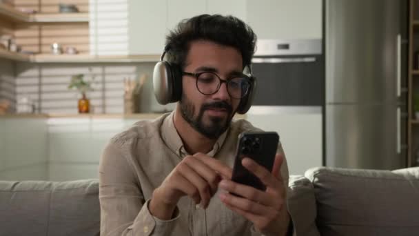 Relaxado Homem Feliz Indiano Árabe Cara Masculino Sorrindo Escolher Áudio — Vídeo de Stock