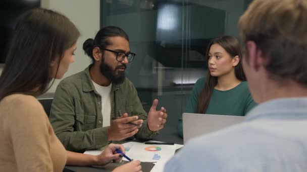 ビジネスチーム 多民族女性 グループ同僚 若いクリエイティブマネージャー オフィス会議テーブルに座ってアイデアを共有 スタートアッププロジェクト 企業ブレインストーミング 職場で交渉 — ストック動画
