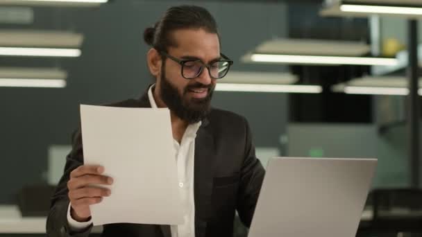 アラビアの男性のインドのビジネスマン男は オフィスでラップトップを入力チェック文書を集中する イスラム教徒のビジネスマンエグゼクティブ専門知識ワーキングコンピュータジョブリーダー ペーパーワークレポートの研究レビューを管理します — ストック動画