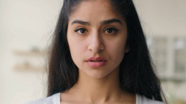 Close up head shot frustrated sad lonely Indian ethnic woman businesswoman looking at camera pensive anxious sight depressed thoughts portrait girl worried with health problem guilt loneliness despair