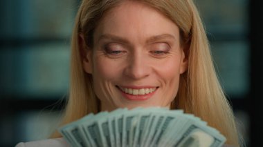 Close up head shot Caucasian 40s woman middle-aged adult businesswoman rich female holding fan counting money check dollars count cash finance salary winning financial growth bills banknotes currency