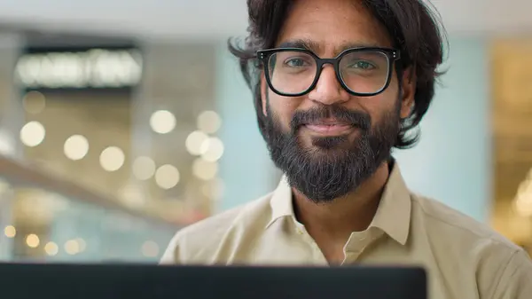 Indian Man Glasses Looking Laptop Screen Working Online Indoors Smiling — Stok fotoğraf