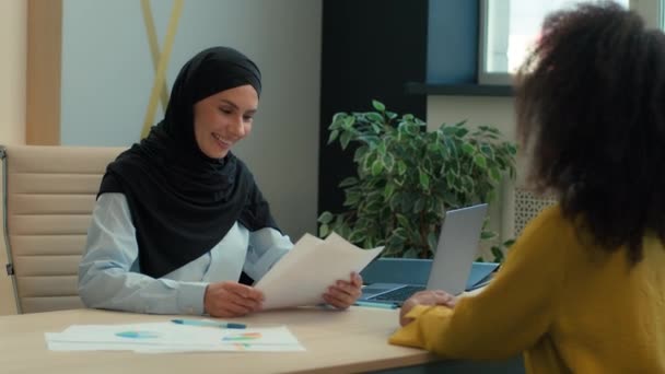 ヒジャブの女性投資家雇用主契約文書に署名するアラビアのイスラム教女性 ビジネス契約パートナーシップ ビジネスウーマンとクライアント協力 オフィスの多民族女性 — ストック動画