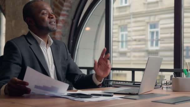 オフィスエスニックビジネスマンのアフリカ系アメリカ人男性マネージャーワーカーリーダー 雇用主 話すビデオ通話会議 プレゼンテーションラップトップを交渉 文書を保持する ビジネス相談 オンライン — ストック動画
